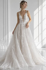 Sleeveless plunging illusion floral lace A-line bridal gown with fitted corset bodice and soft flowing tulle skirt