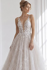 Sleeveless illusion lace floral A-line bridal gown with deep V neckline and soft layered skirt