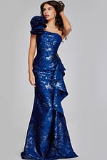 Model in Jovani 39438 navy gown showing one-shoulder design with metallic accents.
