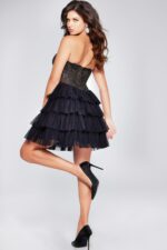 Back view of model wearing Jovani 39629 black dress with layered tulle skirt.
