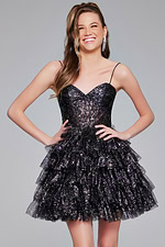 Model in Jovani 39654 black dress with layered ruffle skirt shown from front.