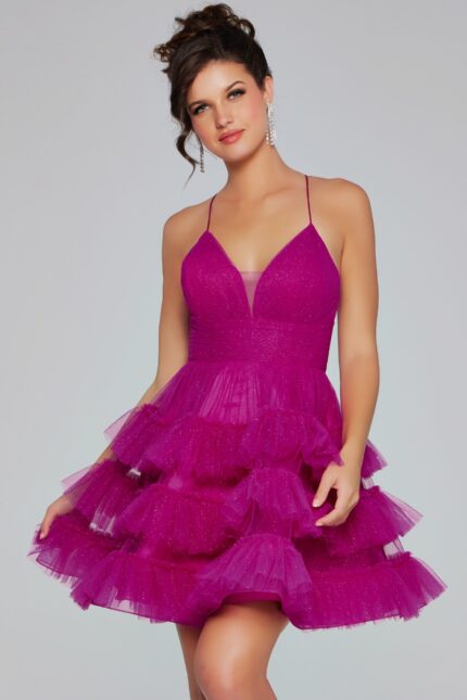 Model wearing Jovani 39655 dress with ruffled tulle and V-neckline in fuchsia.