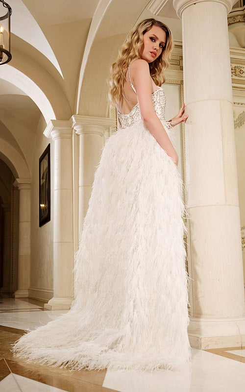 Model showing the back of Jovani 39677 white gown with feather detailing.