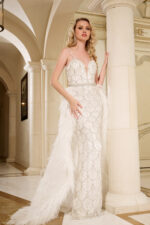 Model wearing Jovani 39677 elegant white gown with feather detailing from the front view.