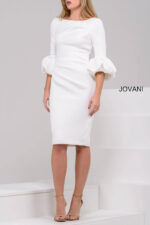 Model wearing Jovani 39738 ivory dress with a fitted silhouette and dramatic puff sleeves.