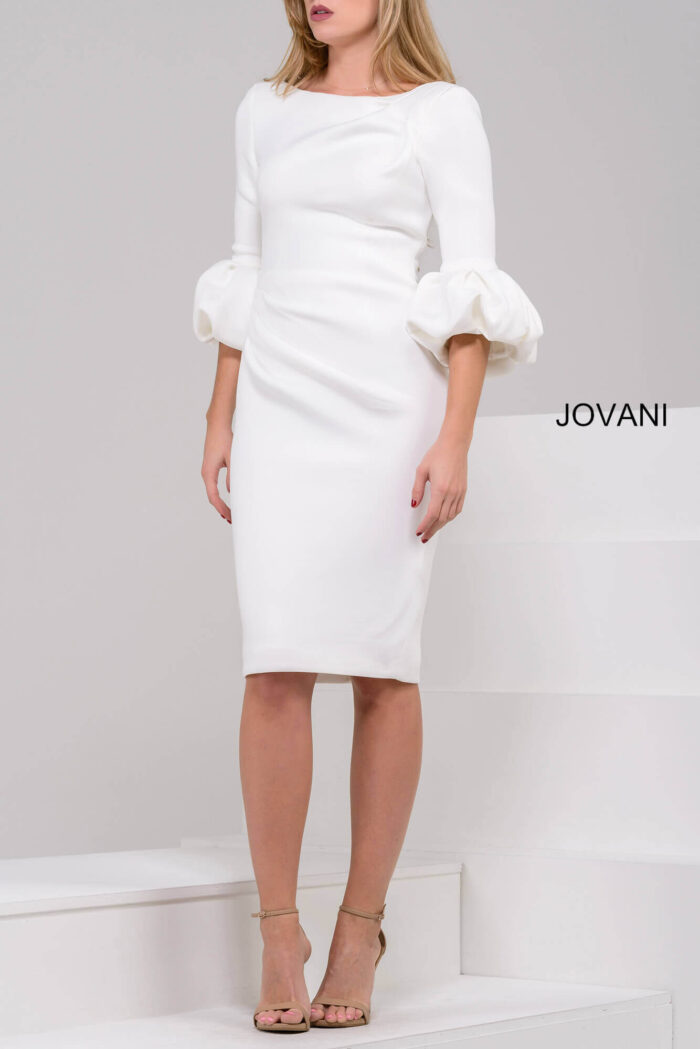 Model wearing Jovani 39738 ivory dress with a fitted silhouette and dramatic puff sleeves.