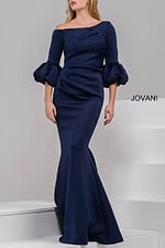 Model wearing Jovani 39739 navy gown with off-the-shoulder neckline and ruched sleeves.