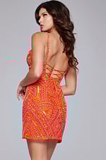 Model wearing Jovani 39790 orange mini dress with lace-up back detail, back view.