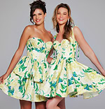 Two models in Jovani 39881 green floral dresses with sweetheart neckline.