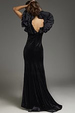 back view of model wearing Jovani 39973 black gown highlighting the voluminous shoulder design