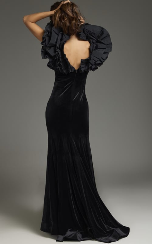 back view of model wearing Jovani 39973 black gown highlighting the voluminous shoulder design
