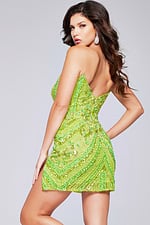 Model in back view of Jovani 40003 green sequin short dress.