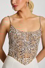 Close-up of intricate silver beadwork on nude mesh top with scoop neckline.