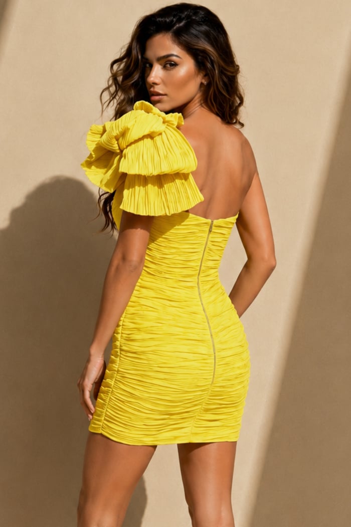 back view of yellow bodycon mini dress with plunge V-neck, voluminous one-shoulder ruffle, and all-over ruching