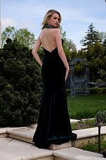 Model wearing Jovani 40119 back view of green velvet gown with open back