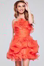 Model wearing Jovani 40144 orange dress, smiling in front view