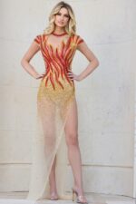 Full-length view of model in Jovani 40157 nude dress with flame beaded design.