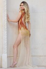 Back view of Jovani 40157 nude dress featuring a high slit and flame embellishments.