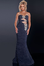 Model wearing Jovani 40174 navy gown with cut-out details and embellishments from the front view.