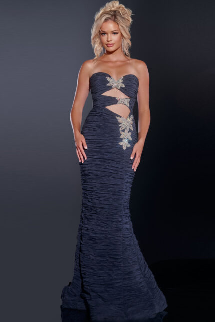 Model wearing Jovani 40174 navy gown with cut-out details and embellishments from the front view.