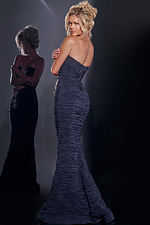 Model wearing Jovani 40174 navy gown showing the back view with ruched detailing.