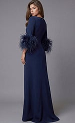 Long navy gown with minimalist neckline and dramatic feather sleeve cuffs