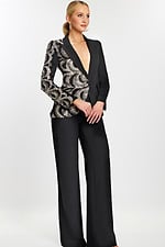 Side angle of black tailored suit with silver and black sequin swirl pattern.