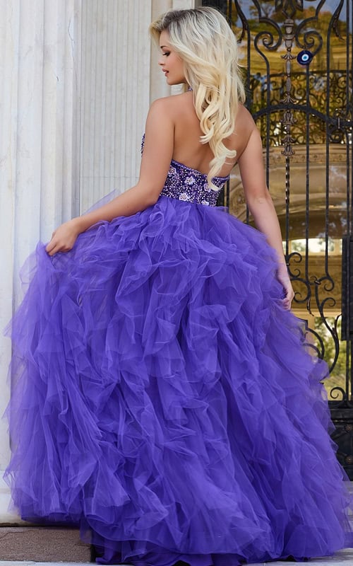 Back view of model wearing Jovani 40218 lilac dress with open back design.