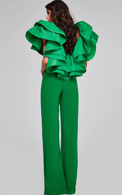 Back view of model wearing Jovani 40291 emerald green jumpsuit showing the ruffled sleeve detail.