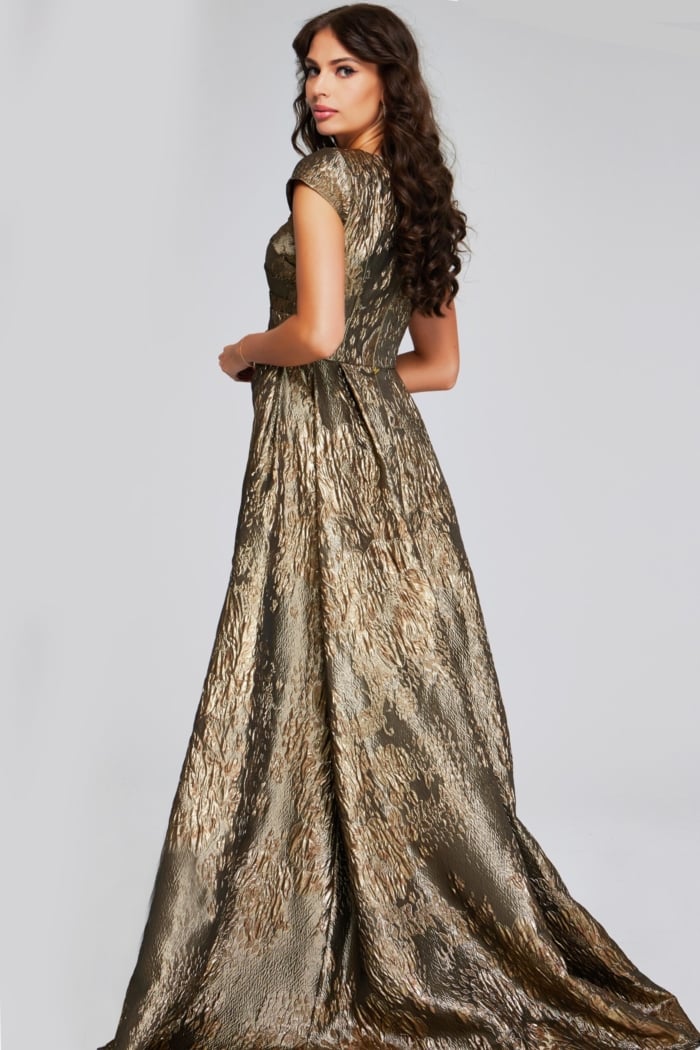 Model wearing Jovani 40295 in metallic green, angled back view with elegant A-line train.
