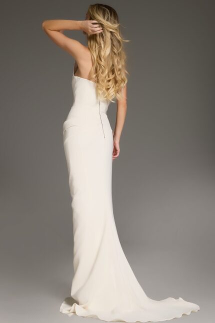 Model wearing Jovani 40301 ivory one-shoulder evening gown, back view.