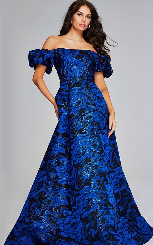 Model wearing Jovani 40315, a royal blue off-the-shoulder gown with puff sleeves.