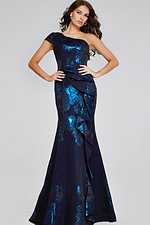 Model wearing Jovani 40320 navy gown with one-shoulder neckline and ruffle details, front view.