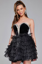 model wearing Jovani 40352 black mini cocktail dress, front view with playful pose