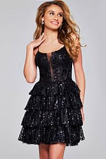 Model wearing Jovani 40386 black mini dress with sequined tiered skirt and illusion neckline.