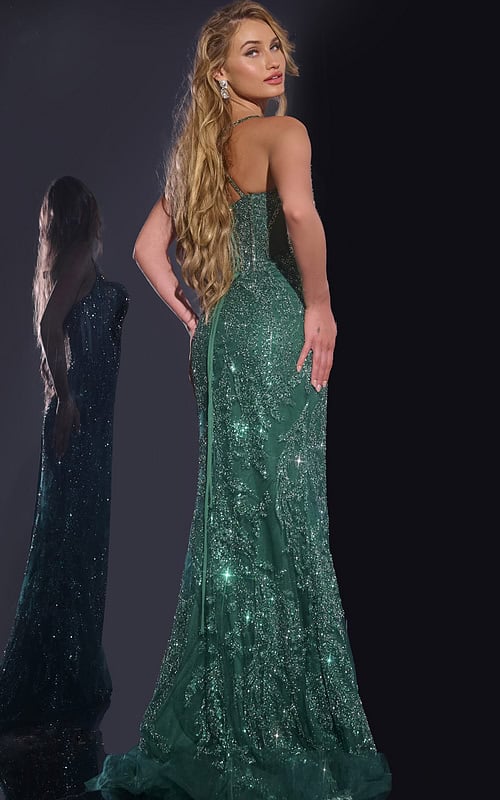 Model wearing Jovani 40470 green mermaid gown with embellishments, back view.