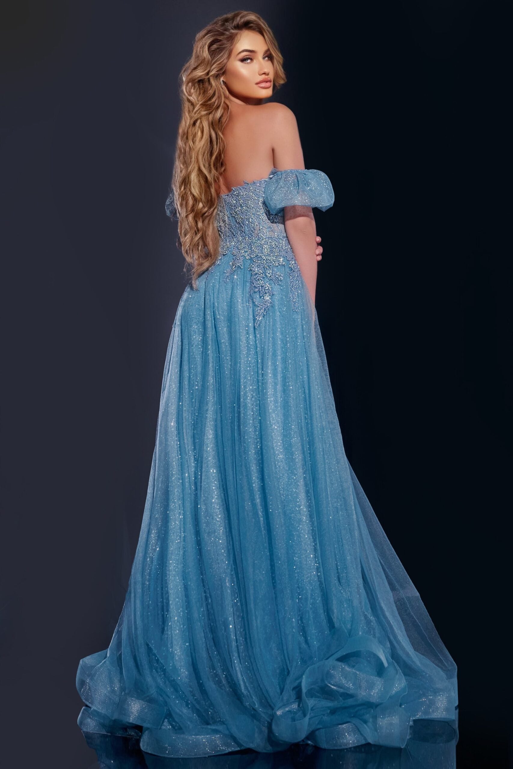 Back view of Jovani 40474 blue gown with elegant draping and puff sleeves.