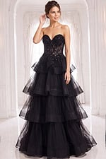 Elegant black evening gown featuring a sweetheart neckline, sheer lace corset top, and voluminous ruffled tulle layers with train detail