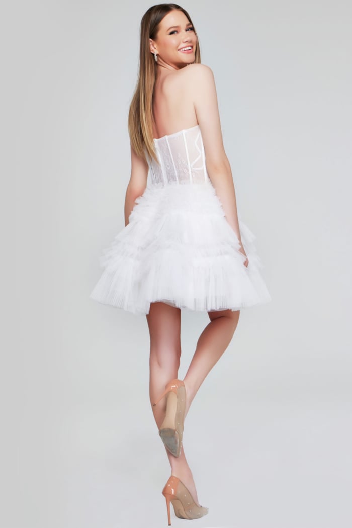 Model showing back of Jovani 40580 dress with layered tulle skirt and lace details.
