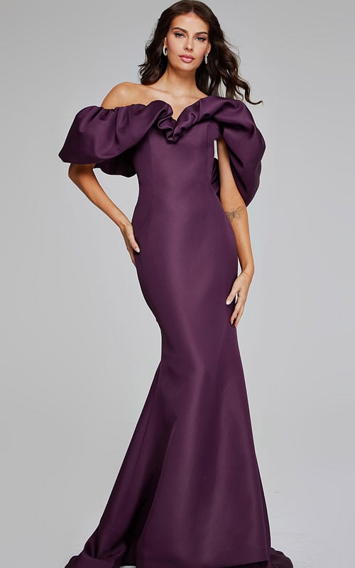 Model wearing Jovani 40596 burgundy gown with off-the-shoulder ruffled neckline and mermaid silhouette.