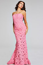 Model posing in Jovani 40744 pink gown with floral applique, front angle.