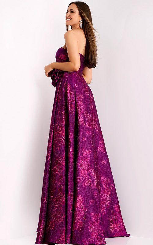 Back view of long formal fuchsia jacquard gown with rosette accent