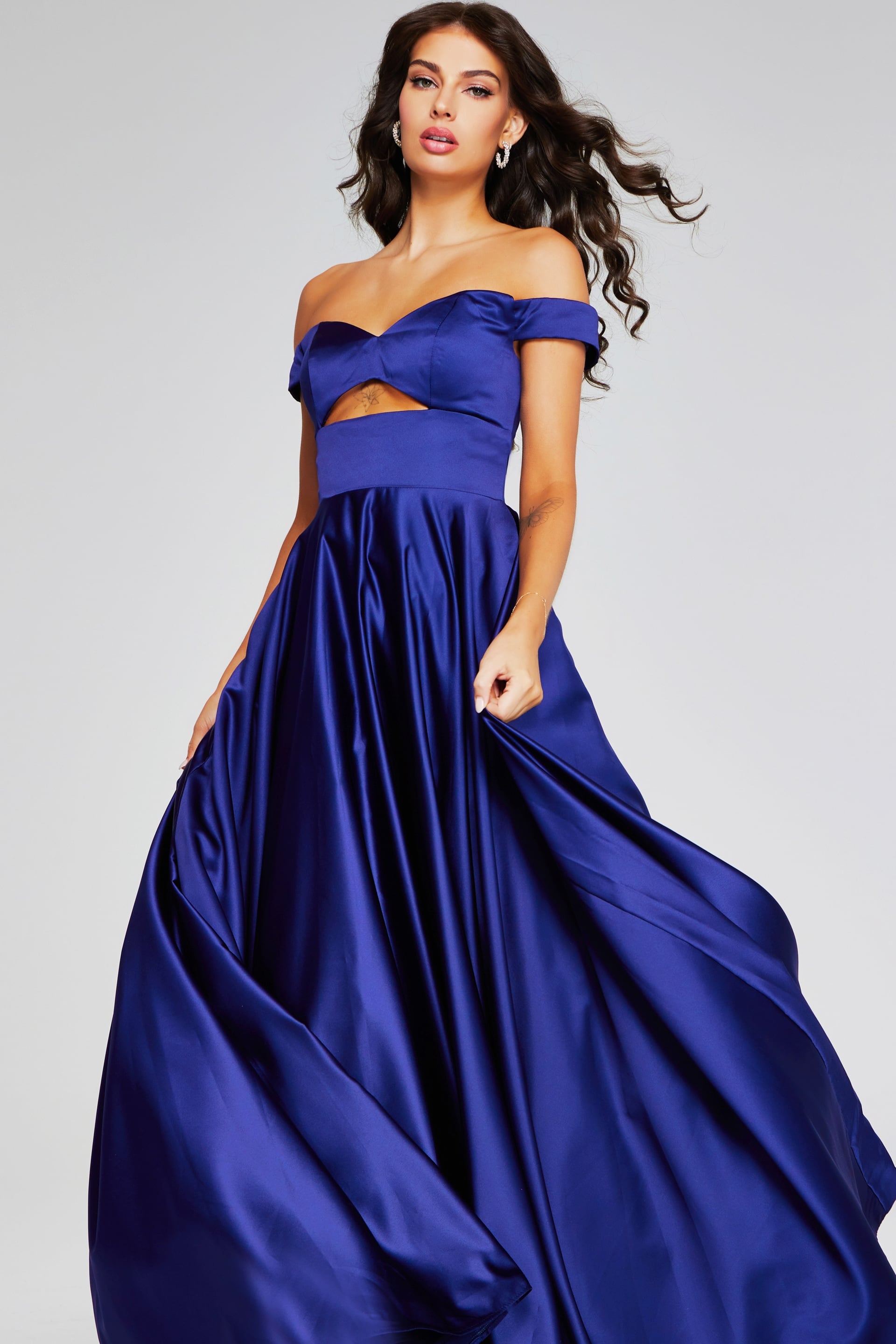 40787-DARKPURPLE-208.jpg Model wearing Jovani 40787 purple off-the-shoulder dress, front view.