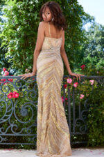 Model wearing Jovani 40877 nude dress showing back view with bead detailing