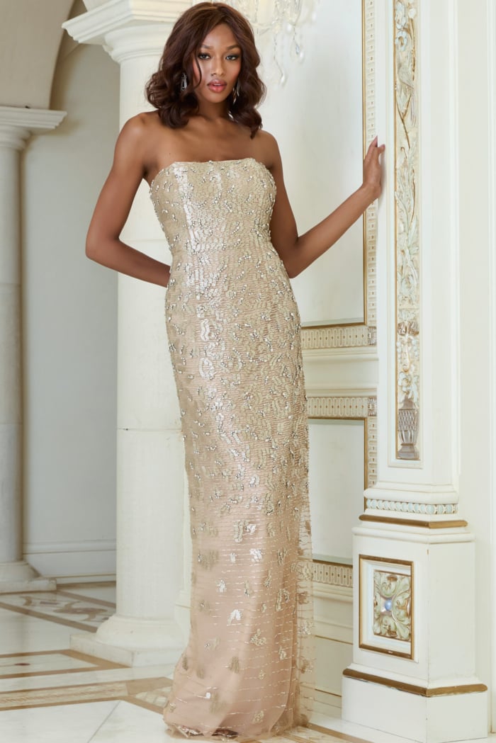 Model in Jovani 40887 nude column gown, details of strapless neckline.