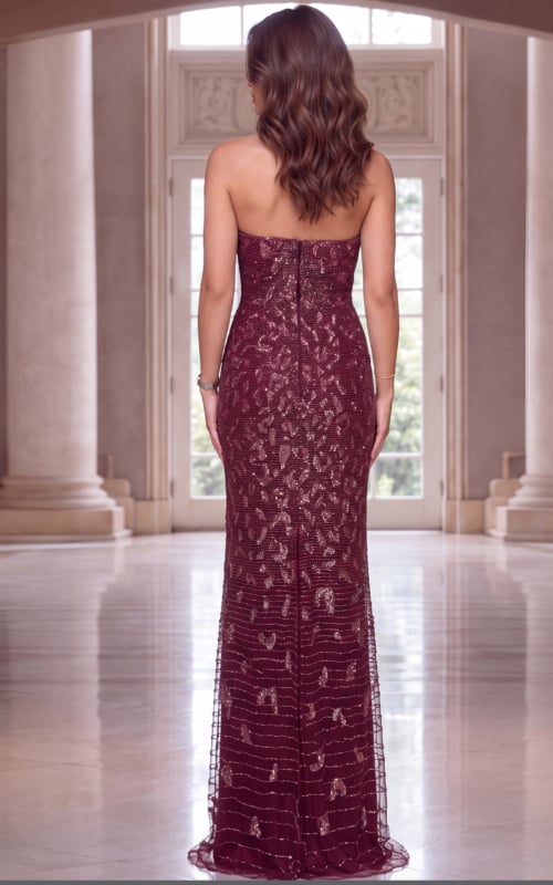 Wine beaded strapless gown seen from behind, fitted column shape with sweeping tulle hem