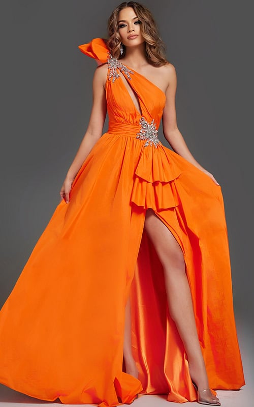 Model wearing Jovani 40929 orange one-shoulder gown with ruffle detailing and high slit