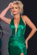 Model wearing Jovani 41012 green gown with high slit and halter neckline.