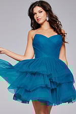 Model wearing Jovani 41054 blue dress, front view showing layered tulle.