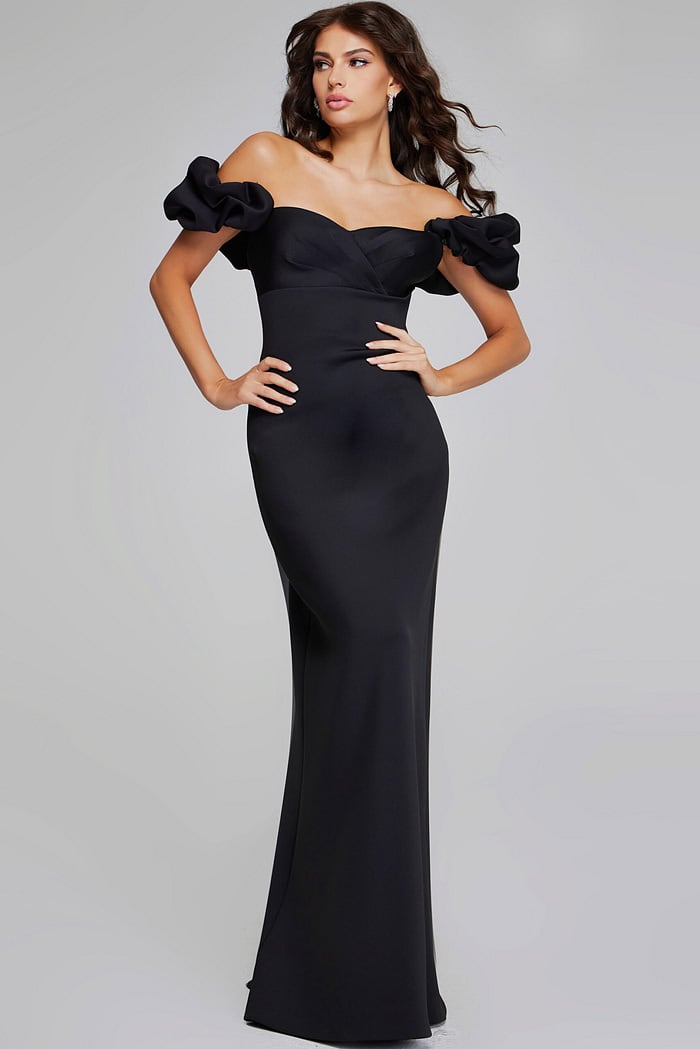 Model wearing Jovani 41084 black off-the-shoulder dress, full front view.